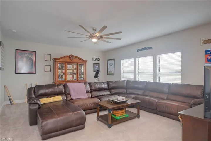 Living room featuring light carpet and ceiling fan