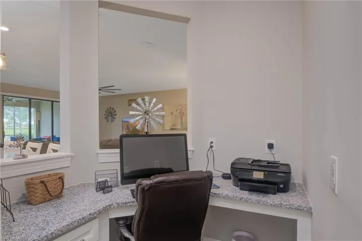 Office area with ceiling fan and built in desk