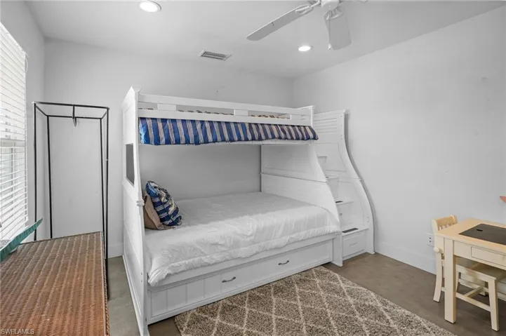Bedroom with a ceiling fan and recessed lighting