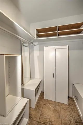 Spacious closet with light tile flooring