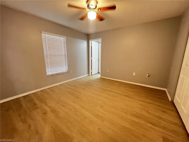 Empty room with light wood-style flooring and ceiling fan