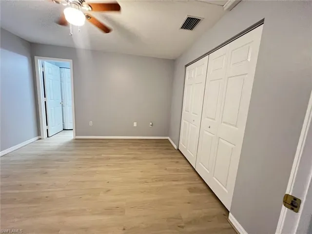 Unfurnished bedroom with light wood-type flooring, a closet, and ceiling fan