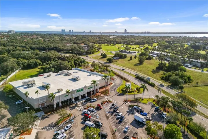 Publix shopping center across the empty field. Greenwood Condo is in the background on the right, El Rio Golf Club on the left
