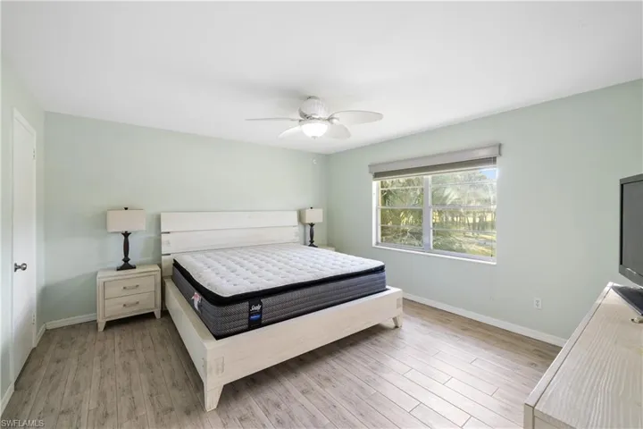 Primary suite. King bedroom set included. Planl tile flooring and updated ceiling fan and light fixture