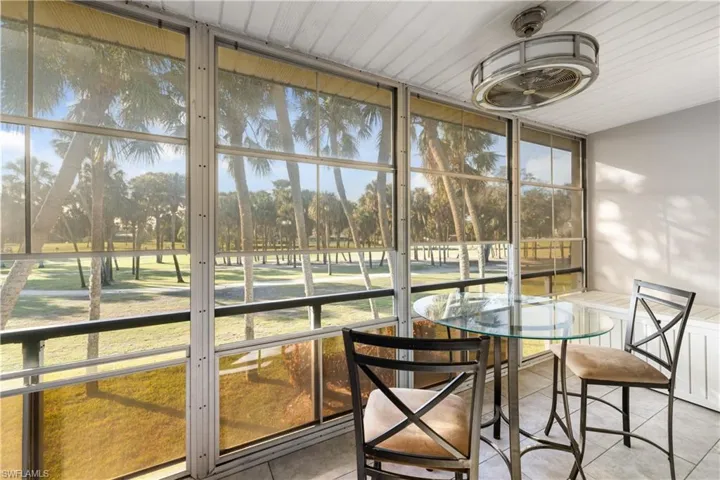 Sunroom/Lanai with a view of the golf course, vinyl windows for cool nights and an upgraded ceiling fan/light fixture