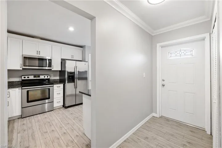 View of front door and kitchen