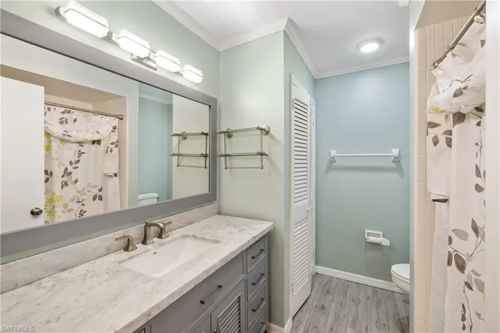 Guest bathroom with updated vanity, tub/shower combo and commode