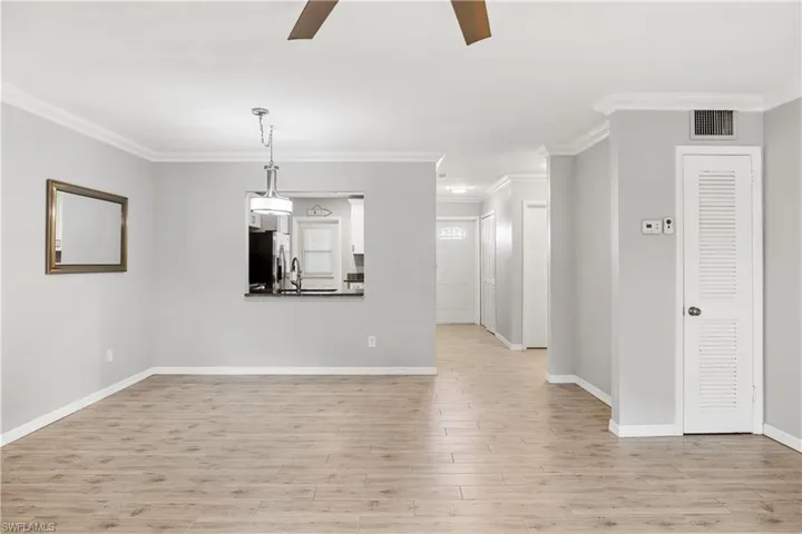 View of dining area, hallway to the front door and guest quarters. Closet to the right stores the air handler