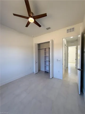 bedroom featuring ceiling fan and a closet