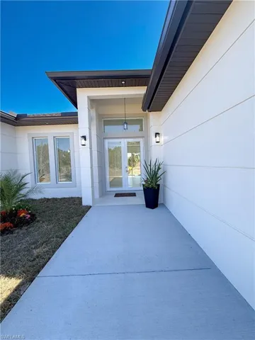 Property entrance featuring french doors and stucco siding