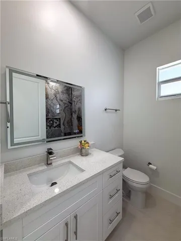 Full bath featuring toilet and vanity