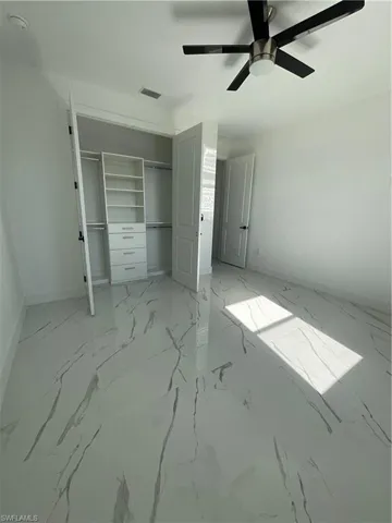 Unfurnished bedroom with a closet and ceiling fan