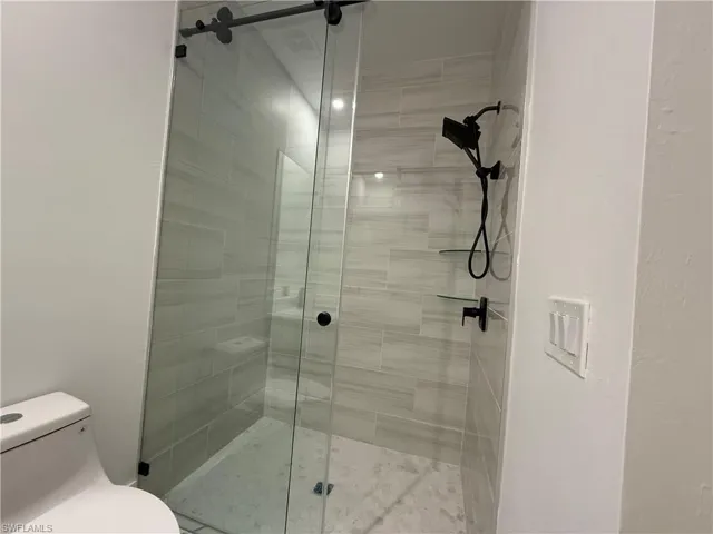 Bathroom with an enclosed shower and toilet
