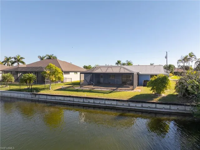 Looking at pool area from canal  Rear of home faces WEST (sunsets)