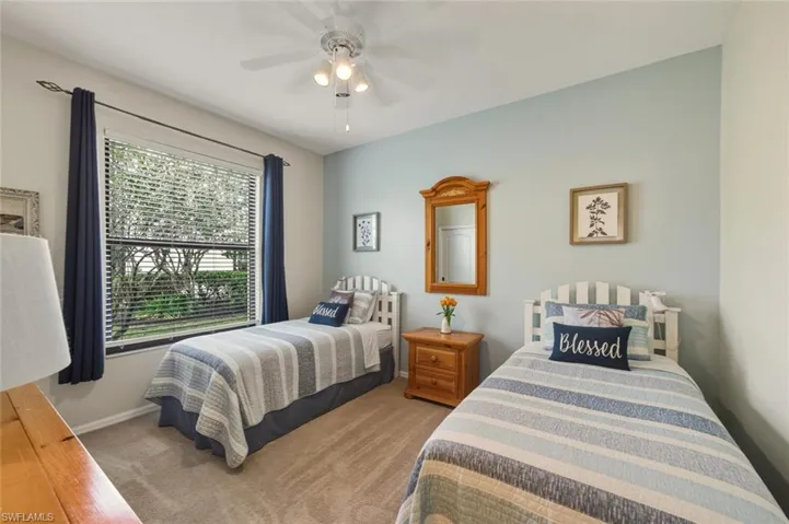 Bedroom featuring light colored carpet and ceiling fan