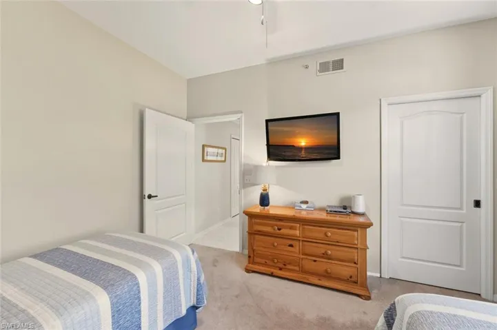 Bedroom with light carpet and baseboards