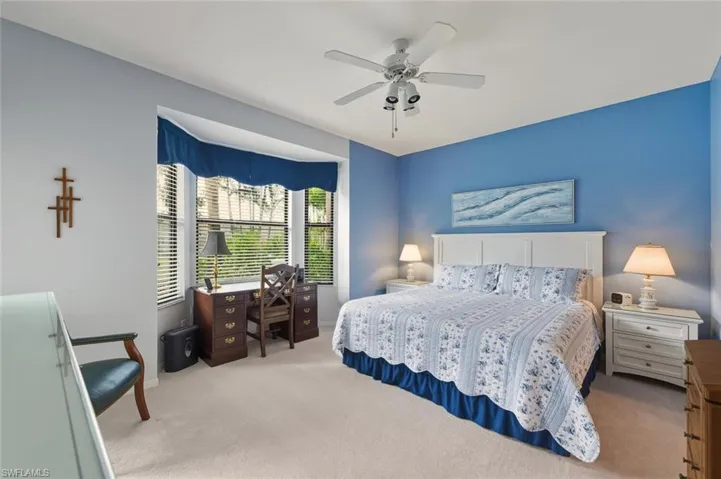 Bedroom with a ceiling fan and carpet floors
