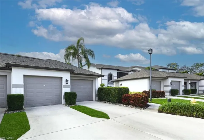 Single story home with stucco siding, roof with shingles, and driveway