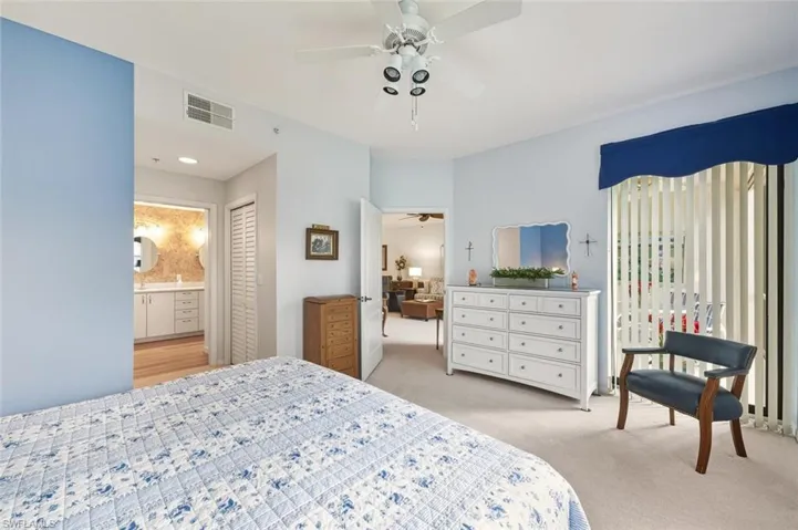 Bedroom featuring light carpet, a closet, and ceiling fan