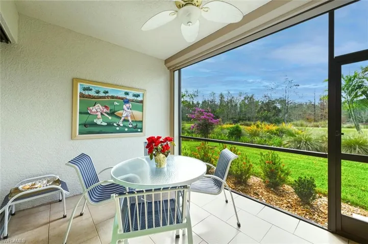 Sunroom with a textured wall and tile patterned flooring