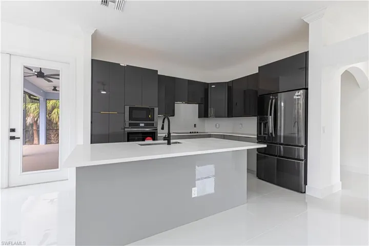 modern cabinets, dark cabinetry, and light countertops