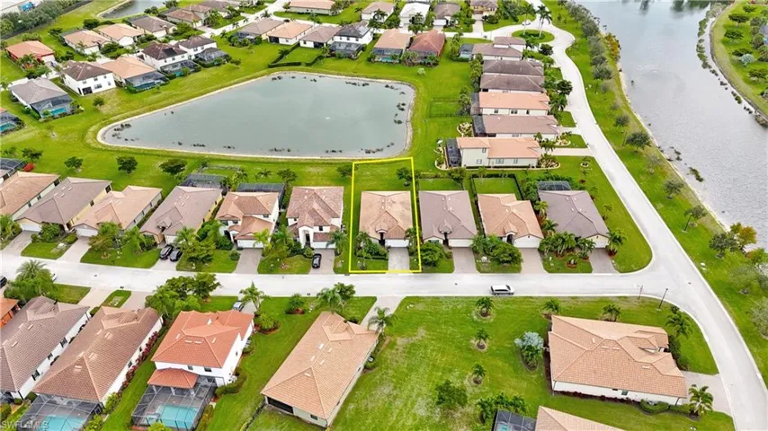 Aerial perspective of suburban area featuring a large body of water