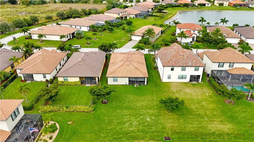 Aerial perspective of suburban area featuring a large body of water