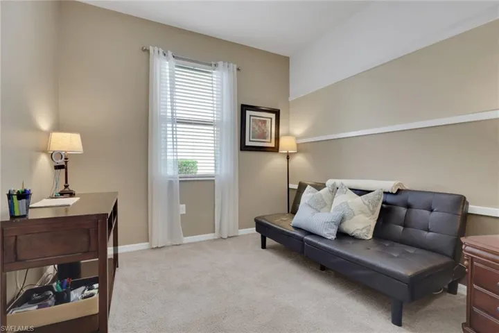 Sitting room with light carpet and baseboards