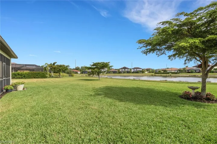 View of grassy yard featuring a water view and a residential view