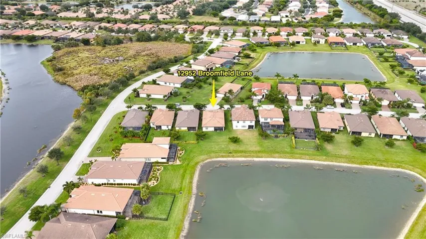 View of property location featuring a large body of water and nearby suburban area