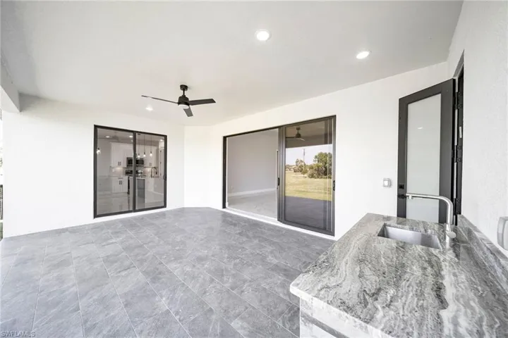 View of patio with ceiling fan and sink