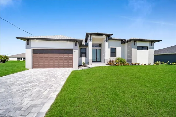 Prairie-style home with a garage and a front yard