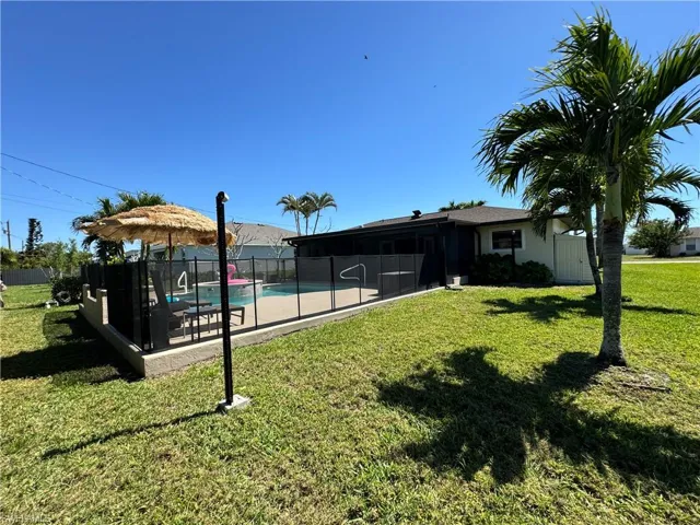 View of yard featuring a fenced in pool and fence
