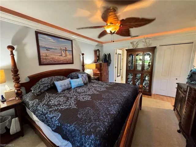 Bedroom with crown molding, a ceiling fan, and visible vents