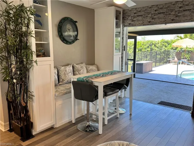 Dining area with breakfast area, a ceiling fan, and wood finished floors