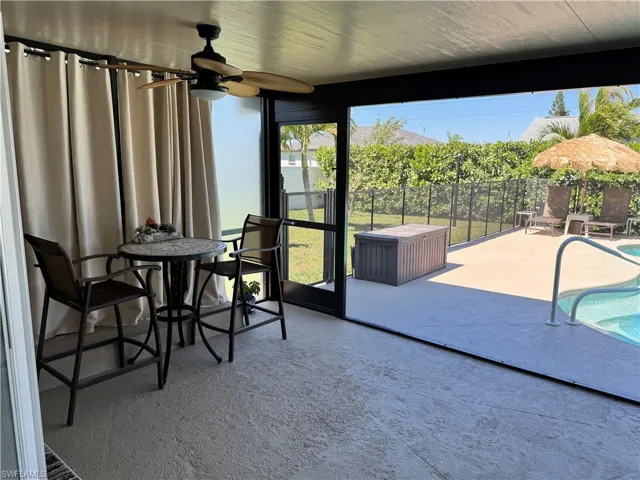 Sunroom with a ceiling fan