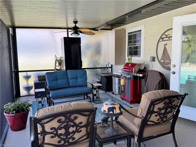 View of patio / terrace with grilling area, outdoor lounge area, and a ceiling fan