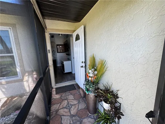View of exterior entry featuring stucco siding