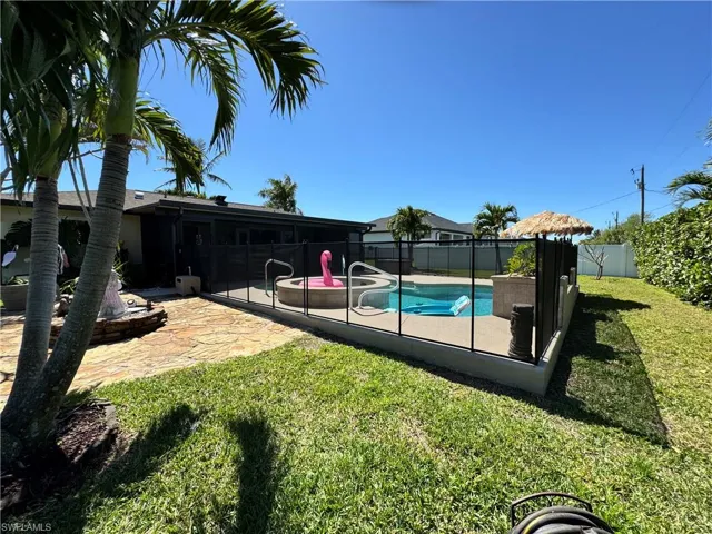 View of swimming pool featuring a yard, a fenced in pool, a fenced backyard, and a patio area
