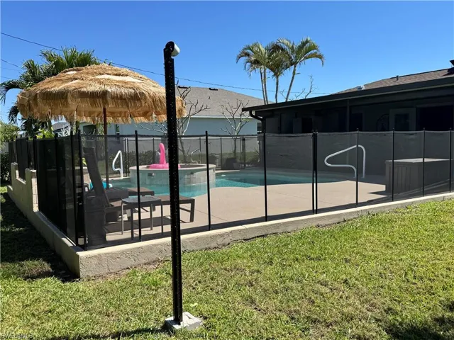 View of pool with a patio area, a fenced in pool, and fence