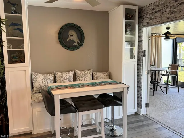 Dining room featuring wood finished floors, a ceiling fan, and breakfast area