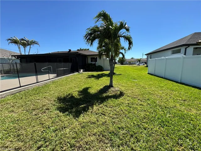 View of yard featuring fence and a fenced in pool