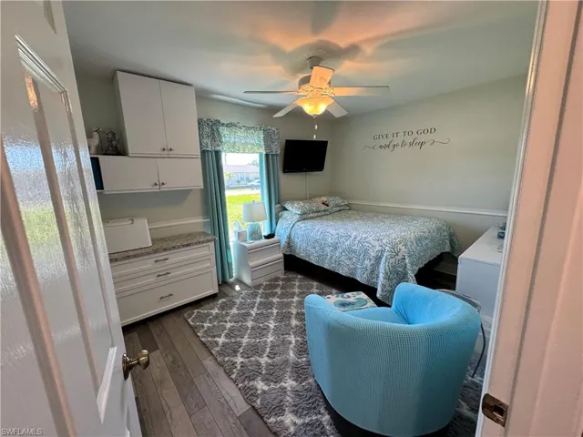 Bedroom with dark wood-type flooring and ceiling fan