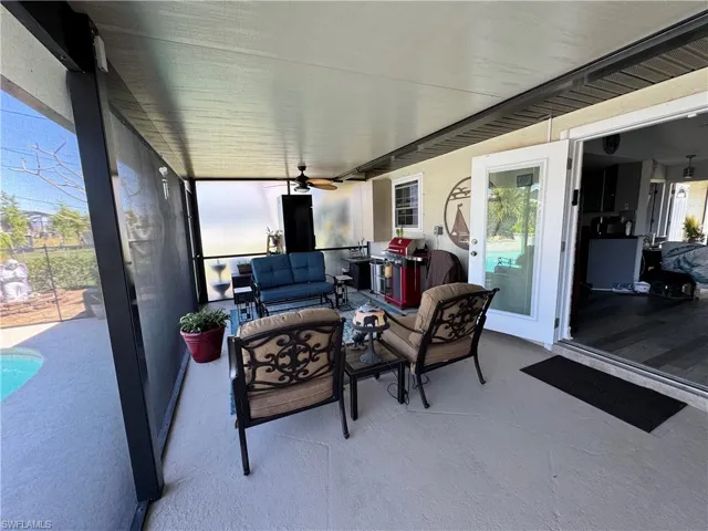 View of patio / terrace featuring an outdoor living space, area for grilling, and ceiling fan