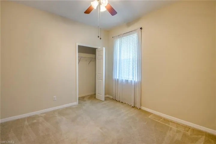Unfurnished bedroom with carpet, a closet, and ceiling fan