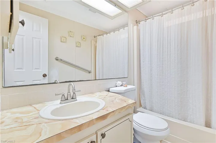Bathroom with vanity, tasteful backsplash, and shower / tub combo