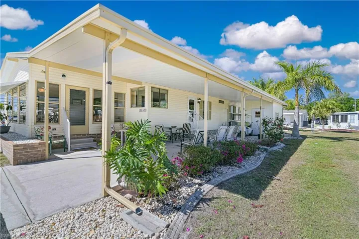 Back of property featuring a patio and a yard