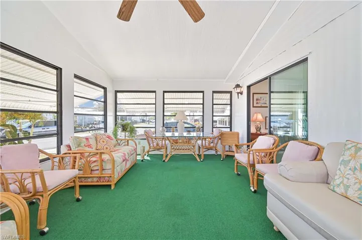 Sunroom with vaulted ceiling and carpet floors