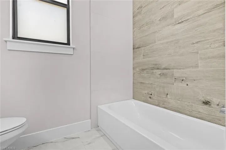 Bathroom with a tub to relax in and toilet