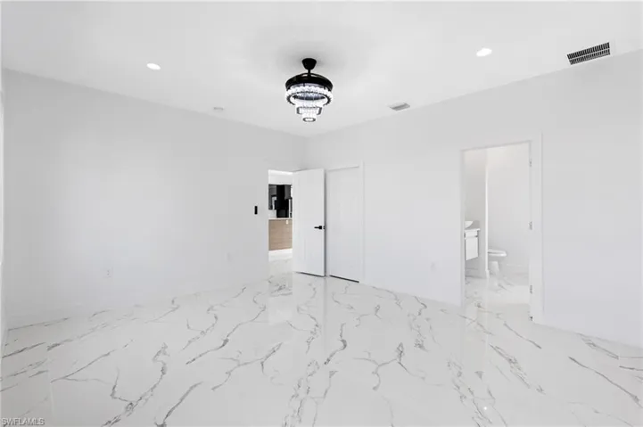 Unfurnished bedroom featuring recessed lighting and connected bathroom